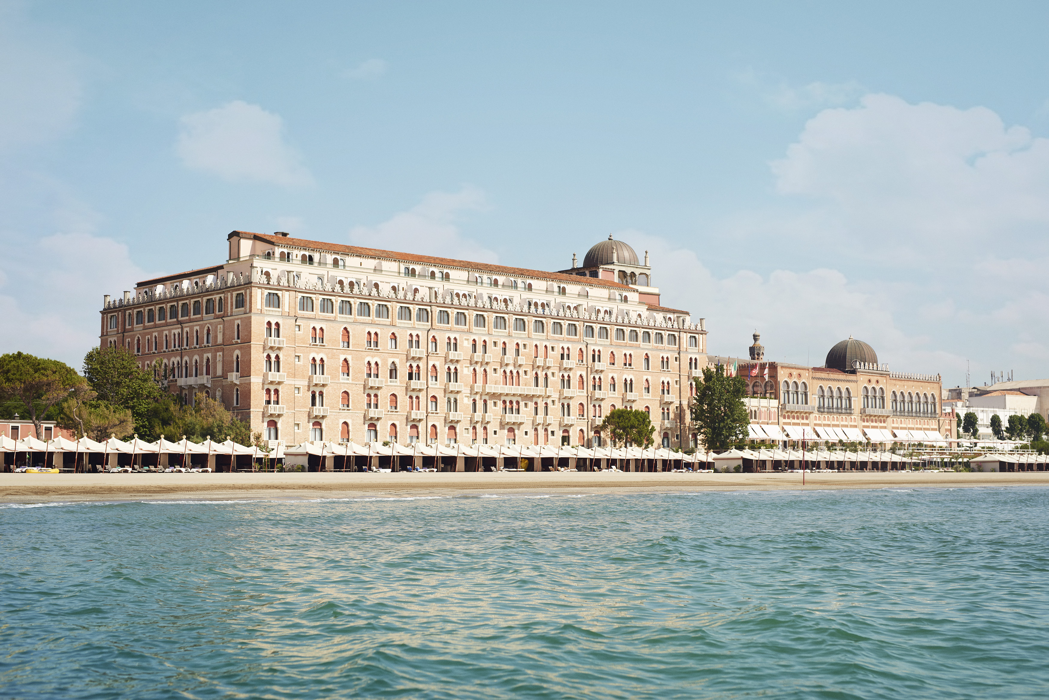 5 star hotel Venice Italy – Hotel Excelsior Venice Lido Resort facade glowing at sunset with Adriatic Sea view, best hotel in Italy Venice