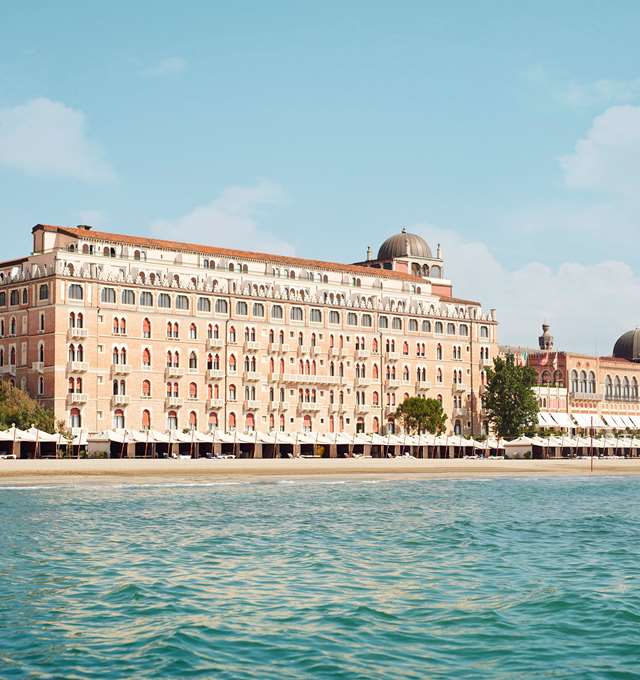 5 star hotel Venice Italy – Hotel Excelsior Venice Lido Resort facade glowing at sunset with Adriatic Sea view, best hotel in Italy Venice