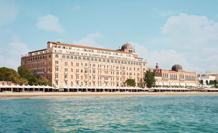 5 star hotel Venice Italy – Hotel Excelsior Venice Lido Resort facade glowing at sunset with Adriatic Sea view, best hotel in Italy Venice