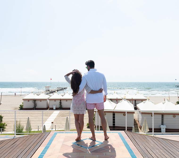 Couple looking the beach of Hotel Excelsior Venice Lido Resort | Beach resort in Venice, Italy