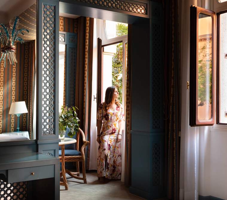A guest overlooking outside her suite | Hotel Excelsior Venice Lido Resort, luxury hotel in Venice, Italy