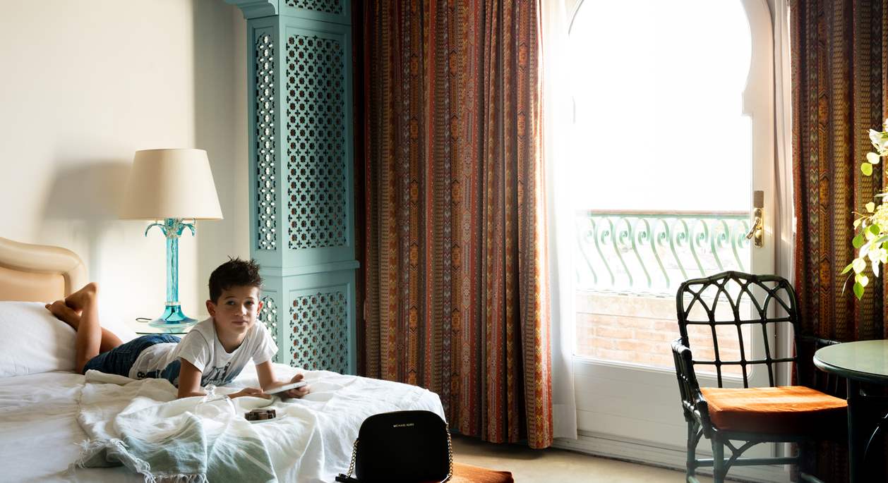A young guest inside his room with sea view | Hotel Excelsior Venice Lido Resort