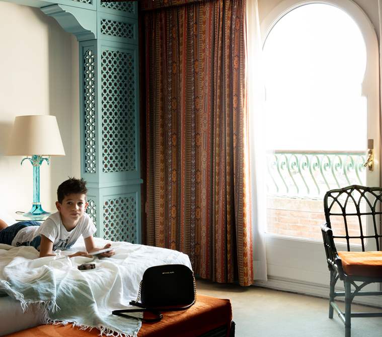 A young guest inside his room with sea view | Hotel Excelsior Venice Lido Resort