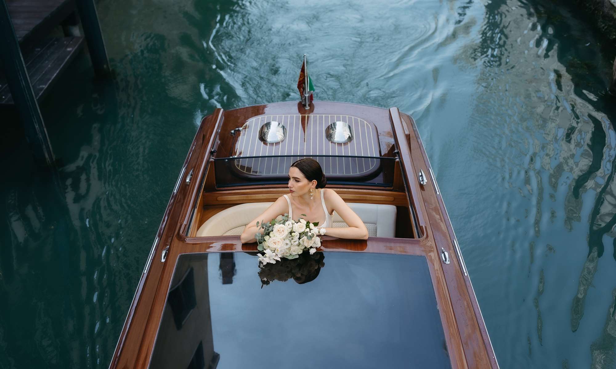 Bride arriving by boat for her Lido beach wedding in Venice, Italy – a unique and unforgettable entrance at Hotel Excelsior Venice Lido