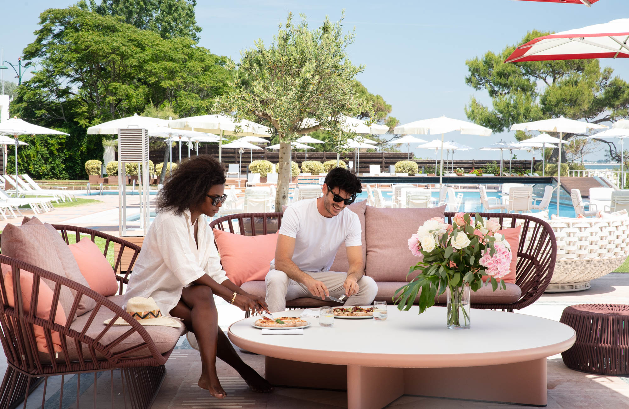 Couple enjoying casual dining in Venice Italy at Hotel Excelsior's poolside lounge.