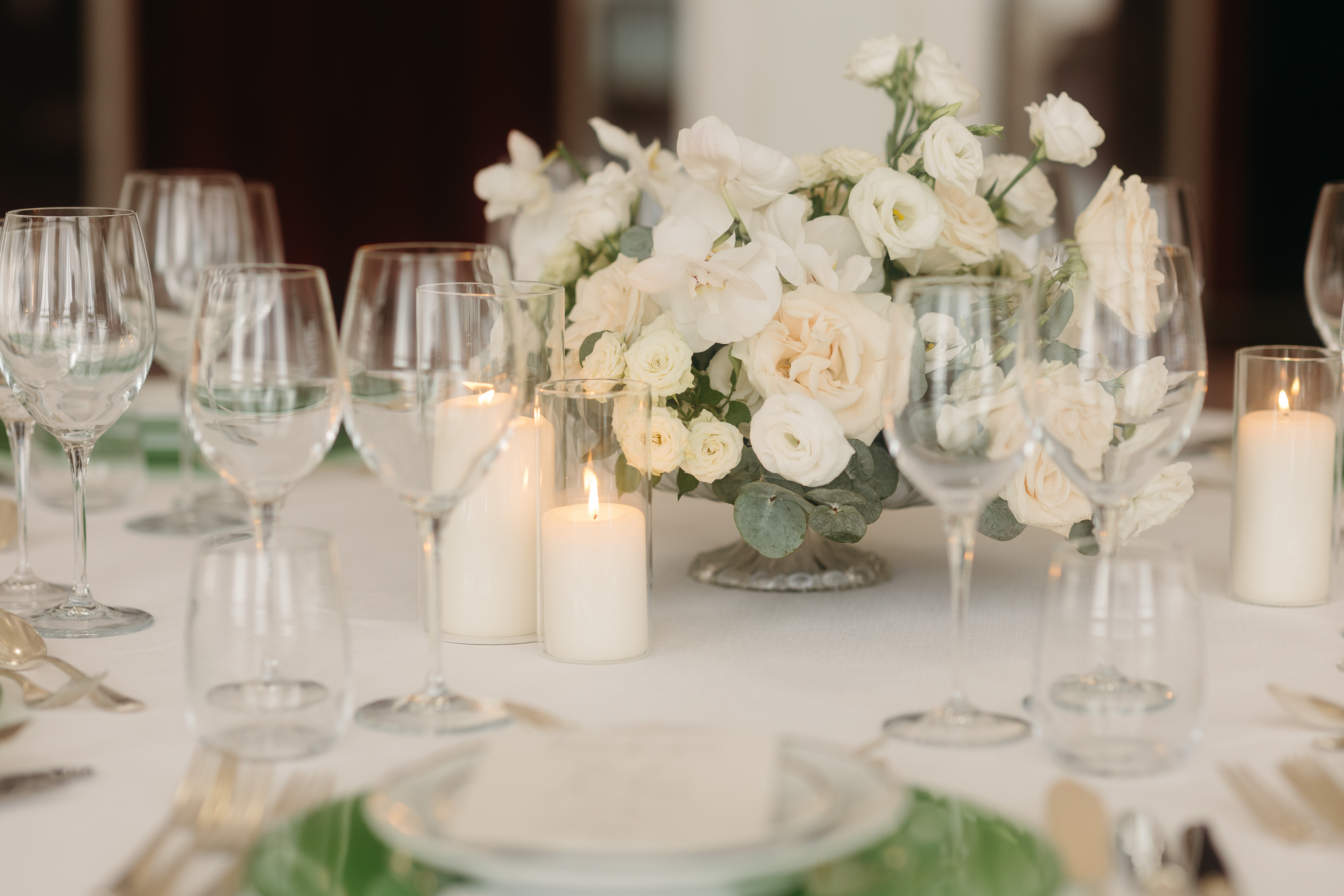 Elegant table setup for a romantic wedding in Venice Italy at Hotel Excelsior Venice Lido Resort, featuring soft candlelight and white roses