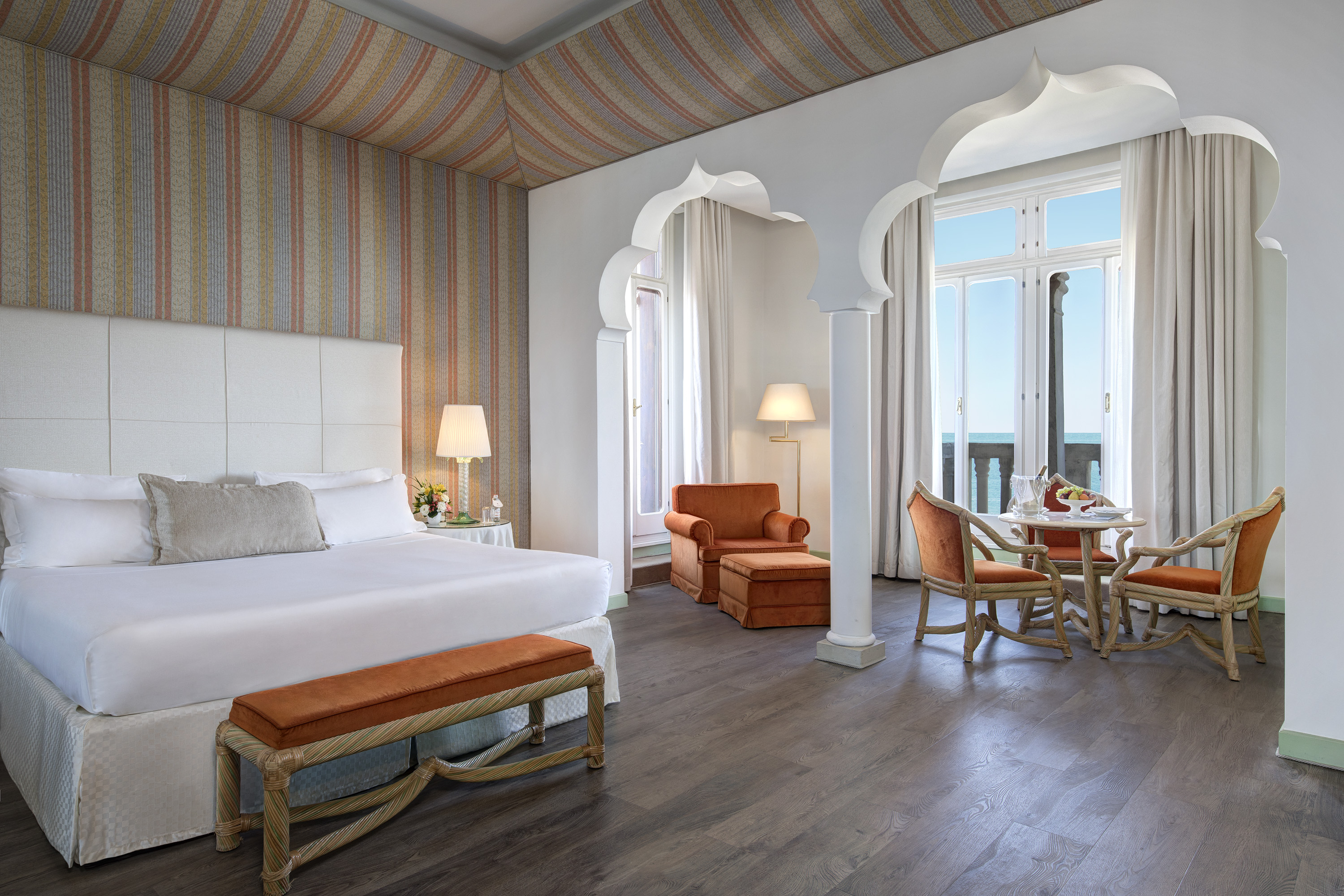 Venetian luxury suite with sea view and elegant seating, one of the finest suites in Venice, Italy.