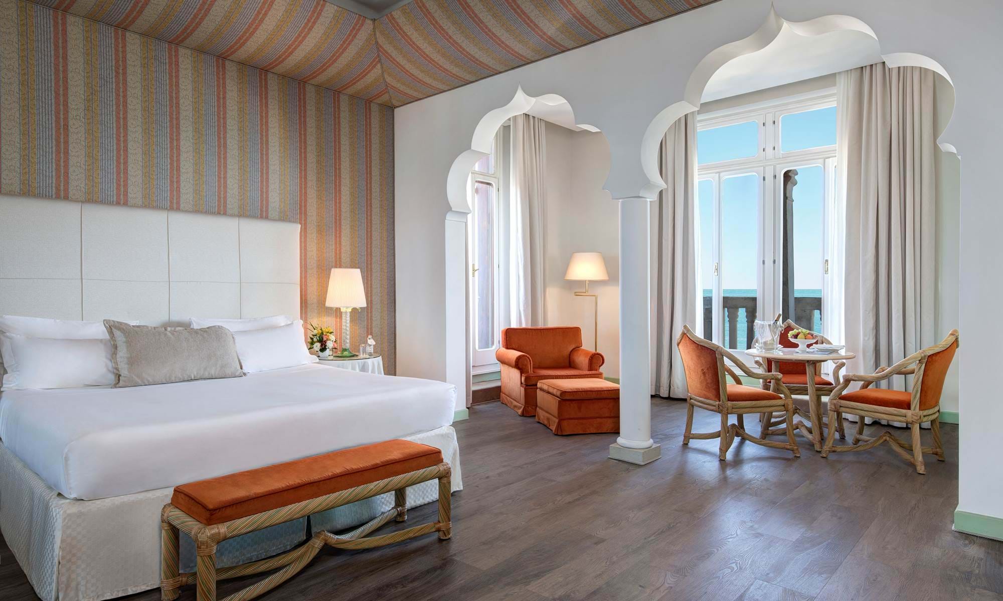 Venetian luxury suite with sea view and elegant seating, one of the finest suites in Venice, Italy.