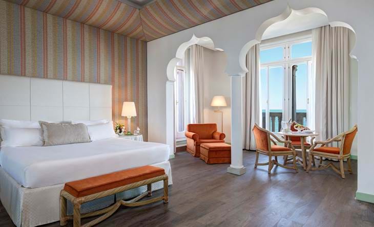 Venetian luxury suite with sea view and elegant seating, one of the finest suites in Venice, Italy.