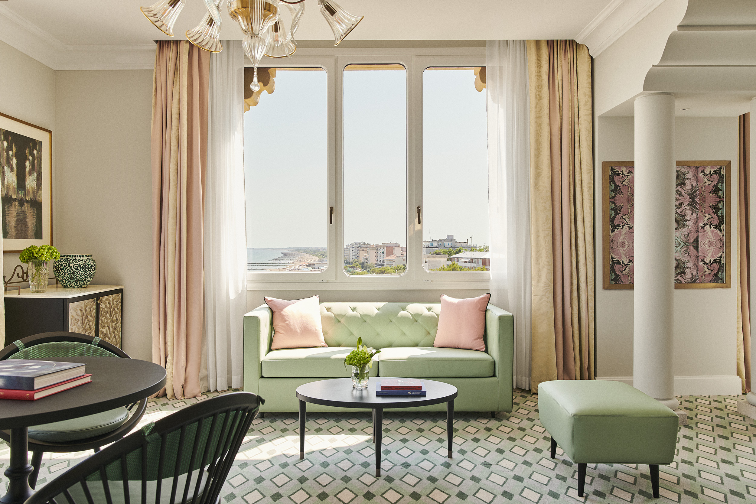 Bright venetian luxury suite overlooking the Lido coastline, reflecting refined suites in Venice, Italy.